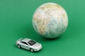 Toy car near the globe. Travel and ecology. Royalty Free Stock Photo