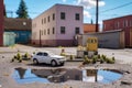 toy car parked in a tiny parking lot with scale model buildings