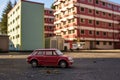 toy car parked in a tiny parking lot with scale model buildings