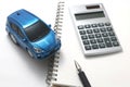 Toy car, pen, calculator, and notebook Royalty Free Stock Photo