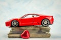 toy car with  pile of money  UK pounds banknotes Royalty Free Stock Photo
