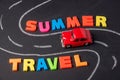 Toy car on the road and inscription plastic letters summer travel on chalkboard