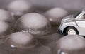 Toy car surrounded by ice cubes. Driving for bad weather concept Royalty Free Stock Photo