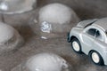 Toy car surrounded by ice cubes. Driving for bad weather concept Royalty Free Stock Photo