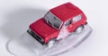 Toy car thaws from ice. defrosting retro toy SUV. close-up on a white background. Timelapse video