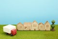Toy car truck and houses on green grass. Royalty Free Stock Photo