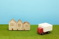 Toy car truck and houses on green grass. Royalty Free Stock Photo