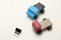 Toy car trucks and miniature laptop on notebook.