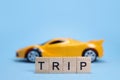 Toy car and word Trip from wooden letters