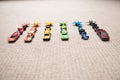 Toy cars collection on carpet.Sorted by color. Transportation, airplane, plane and helicopter toys for children, miniature models Royalty Free Stock Photo