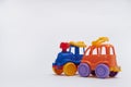 Toy cars collided in an accident on a white background Crash on a toy road