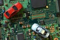 Toy cars on electronic board and microchip. Conceptual image for semiconductor shortage disrupting production of the automotive in