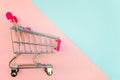 Toy cart on pastel pink and blue background Royalty Free Stock Photo