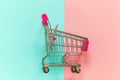 Toy cart on pastel pink and blue background Royalty Free Stock Photo