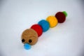 Toy wool caterpillar made of colored balls
