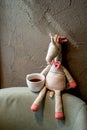 Toy on the chair in coffee house cafe with cup of alternative black filter coffee pour over