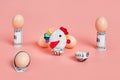 toy chicken and eggshells with 100 dollar bills. concept. pink background Royalty Free Stock Photo