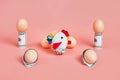 Toy chicken and eggshells with 100 dollar bills. concept. pink background Royalty Free Stock Photo