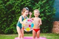 Toy for children games. Children playing with Inflatable rubber beach ball. in water pool. Summer holiday. Boy and Girl Playing in Royalty Free Stock Photo