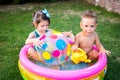 Toy for children games. Children playing with Inflatable rubber beach ball. in water pool. Summer holiday. Boy and Girl Playing in Royalty Free Stock Photo