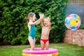 Toy for children games. Children playing with Inflatable rubber beach ball. in water pool. Summer holiday. Boy and Girl Playing in Royalty Free Stock Photo