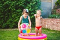 Toy for children games. Children playing with Inflatable rubber beach ball. in water pool. Summer holiday. Boy and Girl Playing in Royalty Free Stock Photo