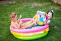 Toy for children games. Children playing with Inflatable rubber beach ball. in water pool. Summer holiday. Boy and Girl Playing in Royalty Free Stock Photo