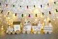 Toy Christmas train with gifts and figures on it. Miniature winter toy with lights and garland Royalty Free Stock Photo