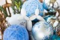 Toy for the Christmas tree in the form of a dog lies on a background of blue Christmas balls. 3d toys Royalty Free Stock Photo