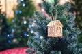 A toy on the Christmas tree in the form of a wooden house Royalty Free Stock Photo