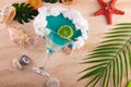 Toy cocktail. Top view on martini glass with blue drink, white foam lay on summer sand. Red starfish, shells, green palm Royalty Free Stock Photo