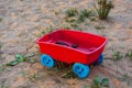 Toy colored children`s cart with cones on the sand Royalty Free Stock Photo