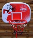 A toy, colorful board with a basketball net