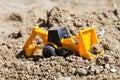 Toy construction machinery in black sand Royalty Free Stock Photo