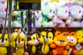 Toy crane vending machine, claw game or cabinet to catch the toys. Shopping, holiday activity, game of chance. Selective Royalty Free Stock Photo