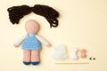 A toy crocheted, a doll in a blue dress, an unfinished work - the hair is not sewn and the decor is not executed.