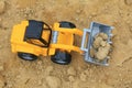 Toy digging machine on the sand Royalty Free Stock Photo