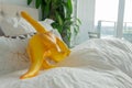 Toy dinosaur in parent bed, depicting parenting lifestyle and a real home