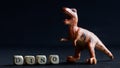 Toy dinosaur similar to Velociraptor, Tyrannosaurus, Allosaurus, Megalosaurus, or Plateosaurus stands on a black background next