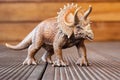 Toy dinosaur triceratops on the wooden floor