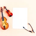 Toy double bass, violin and white mockup blank on pink background, top view Royalty Free Stock Photo