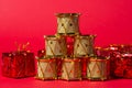 Toy drums gold color on red background. Christmas decorations on a red background. Christmas decorations. Royalty Free Stock Photo