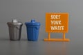 Toy dustbin and plastic board written with SORT YOUR WASTE