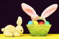 Toy Easter bunny and basket full of coloured easter eggs Royalty Free Stock Photo