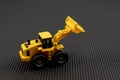 Toy excavator construction machine on black background. Construction concept Royalty Free Stock Photo