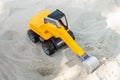 Toy excavator digging sand Royalty Free Stock Photo