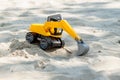 Toy excavator digging sand Royalty Free Stock Photo