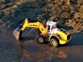Toy excavator, in the sand