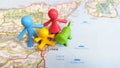 A toy family and dog standing together over Catania on a map of Sicily Royalty Free Stock Photo