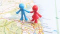 A toy figure couple standing over Newcastle Upon Tyne on a map of England portrait